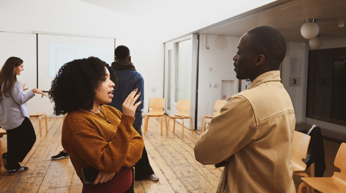 Two young people talking in workshop space