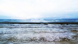 A sequence of waves lapping on a beach