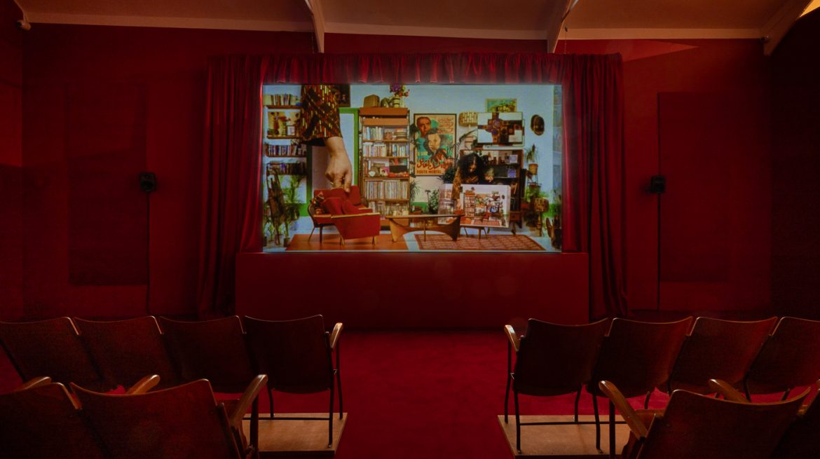 Cinema room with red curtains and chairs
