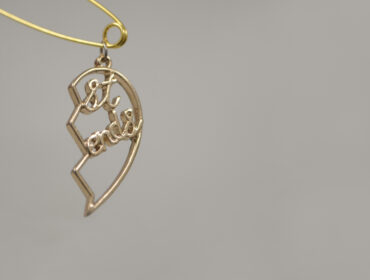 1. Ocean Baulcombe-Toppin, Connection Things (No.2), 2026. Repurposed objects - Split heart necklace pendant, safety pin